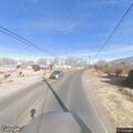 Woman chasing loose dog in roadway
