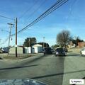Driver reported swerving in green pickup near downtown