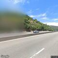 Small sedan stopped on blind curve shoulder