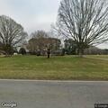 Two men riding dirt bikes on private road