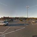 Box truck backs into building at business parking lot