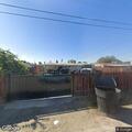 Fence fire threatening house on Sycamore Street
