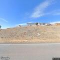 Small roadside brush fire near structure on NM 250