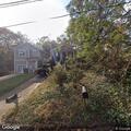 Sick dog confined in metal cage at Clayton home
