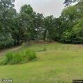 Suspicious person in field behind residence