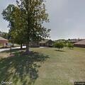 Vehicle damaged fence, car parts scattered in yard