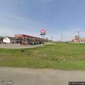 Person with possible heart attack in gray Kia minivan