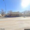 Suspicious person on sidewalk near auto shop