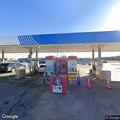 Person passed out in car running at gas station