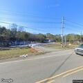 Two individuals slumped over the wheel at Midway Rd