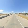 Woman walking along I-25 near exit 212 in Casper