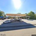 Non-injury crash involving car and deer at gas station