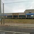 Person sleeping in car wash parking lot