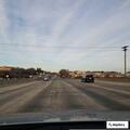 Red Dodge Charger with four occupants on I-85