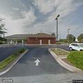 Person with unknown condition lying unresponsive at bank