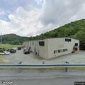 Possible homeless camp behind trailer near creek