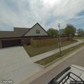 Officer serving warrant on McCray Avenue