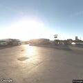 Officer checks white sedan at truck stop