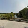 Unoccupied boat stuck on rock in river at Roaring River Rd