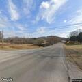 Man standing on four-wheeler by I-35 overpass for welfare check