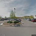 Patient awaiting help in red car at medical center parking
