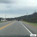 Truck hauling trailer with loose wheel on Highway 10