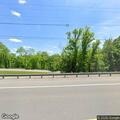 Car with flat tire on highway shoulder