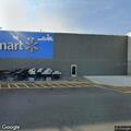 Man pacing in Walmart parking lot with backpacks