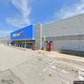 Elderly woman standing in roadway near Walmart