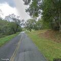 Tree partially blocking lane on Crooked Creek Road