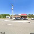 Officer checks on parked car at Nester Store