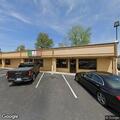 Person running through parking lot near Los Pinos
