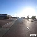 Officer checks two people at bus stop