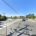 Person walking on Soquel Drive with vodka bottle