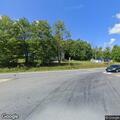 Young boy sitting near road with bike on Route 133