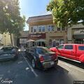 Person in wheelchair with chronic pain at cafe parking lot