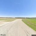 Car overturns in field, driver trapped and injured