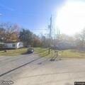 Limb on power line near abandoned house in Scott City