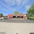 Officer checks unoccupied gray Subaru at Quick Lube