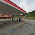 Man asking customers for rides at gas station