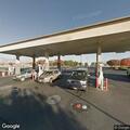 Small brush fire in parking lot near gas station