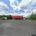 Person in distress leaning against wall at Kegley store