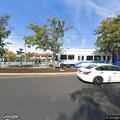 Person experiencing back pain near light rail station