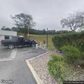 Woman having chest and shoulder pain at gas station
