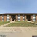 Shirtless man with stick yelling at Bolivar apartments