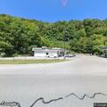 Man standing in roadway near 7-Eleven