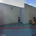 Person passed out on train platform bench at Colma