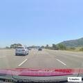 Airport shuttle bus displays emergency sign on Highway 101