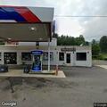Traffic crash at gas station with injured driver