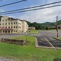 Female waving in road near college apartments appearing disoriented